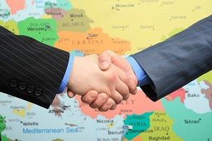 Business handshake over world map background